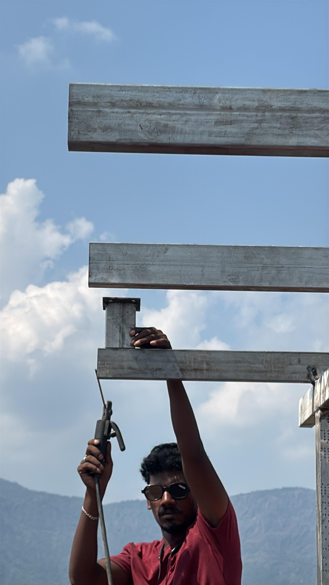 A Quadbiz installer fabricating the mounting frame on site